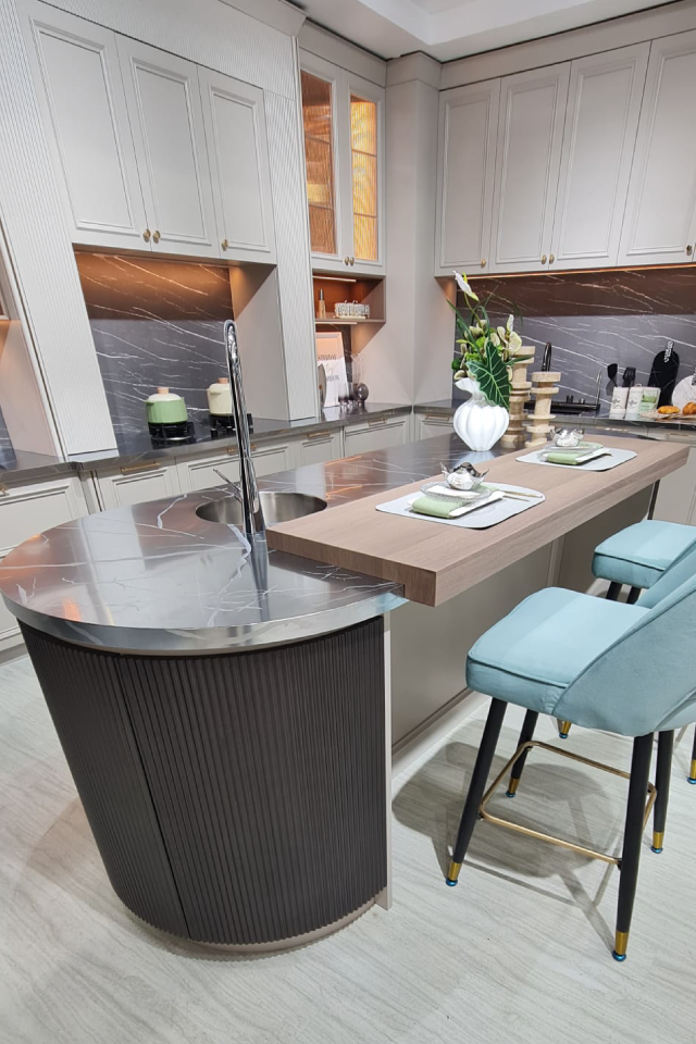 Neutral kitchen with a curved island and integrated dining area